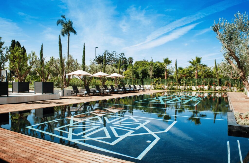 A swimming pool framed by loungers at one of the best Rabat hotels with a pool for 2025