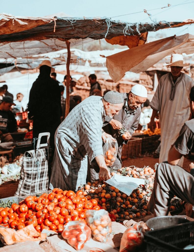 Best things to do in Tafraoute - Elderly Moroccan men shopping for produce at a local market