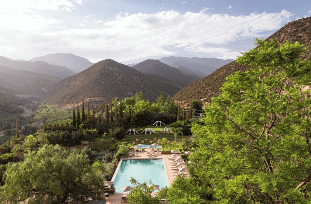 A swimming pool backed by the snow-capped peaks of the Atlas Mountains at The Capaldi, a luxury hotel near Marrakech