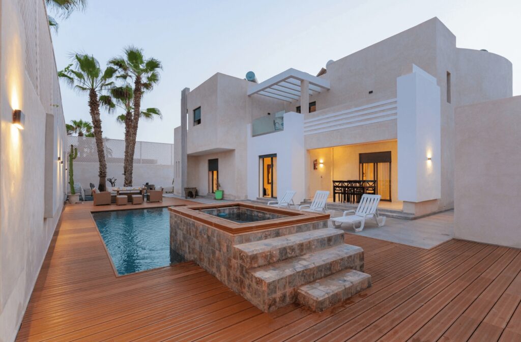 An outdoor pool and dining terrace at one of the best places to stay in Mirleft