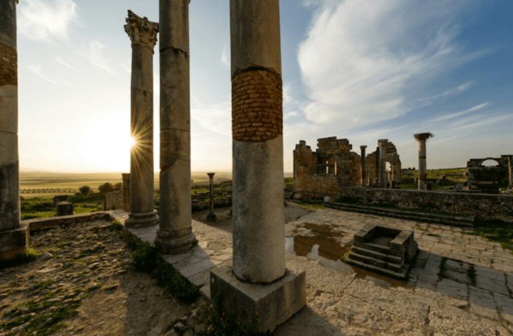 Best things to do in Meknes - A low sun illuminates the Roman ruins at Volubilis