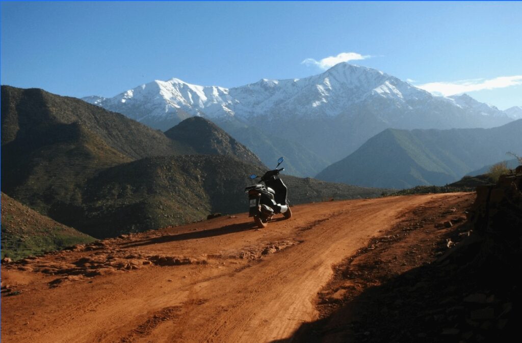Best things to do in Ourika: A motorbike backed by the Atlas Mountains in the Ourika Valley
