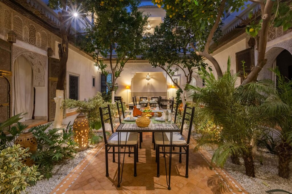 Dining at nighttime in the interior courtyard of Riad Tchaikana, one of the best family hotels in Marrakech