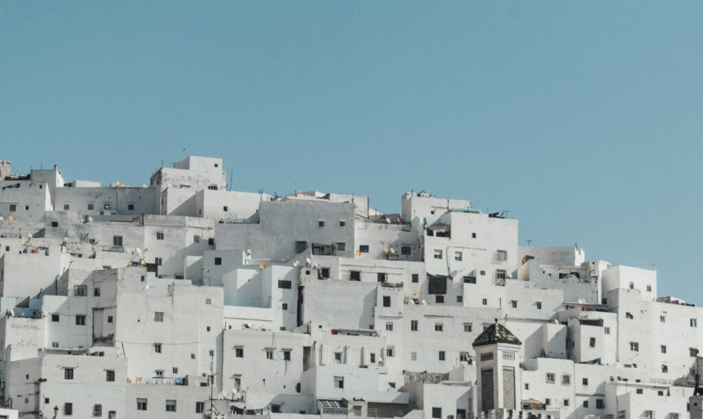 Travel guide to Tetouan: Whitewashed buildings clustered on a hillside in Tetouan, Morocco
